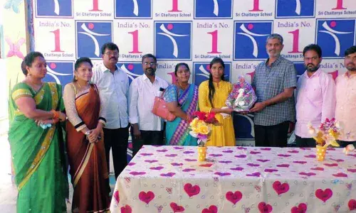 Sri Chaitanya schools AGM Suresh felicitating a student N Srujana with a flower bouquet in Kurnool on Saturday