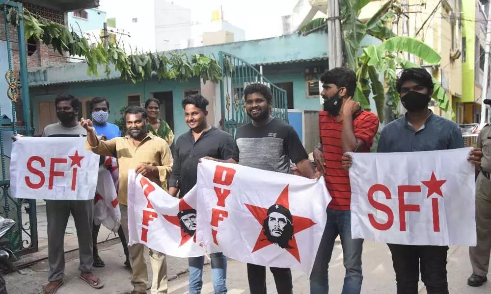SFI and DYFI members  staging protest against job calendar, at CPI office in Tirupati on Sunday