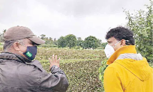 Army veteran Santhosh Kumar and Bengaluru Urban Deputy Commissioner J Manjunath at a lake