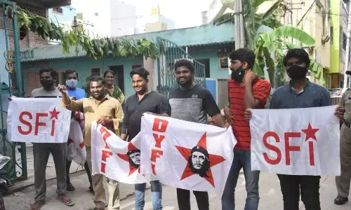 SFI and DYFI members  staging protest against job calendar, at CPI office in Tirupati on Sunday