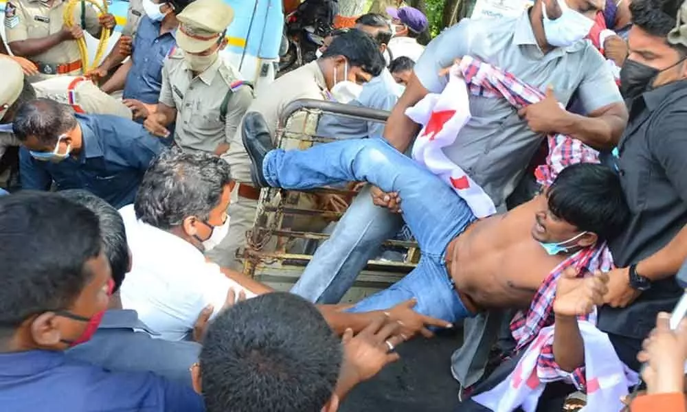 Police arrest a student after preventing a rally towards Chief Ministers residence by student unions, at Tummalapalli Kalakshetram in Vijayawada on Monday