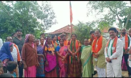 District BJP president Aruna Tara hoisting the BJP flag in Kamareddy on Monday