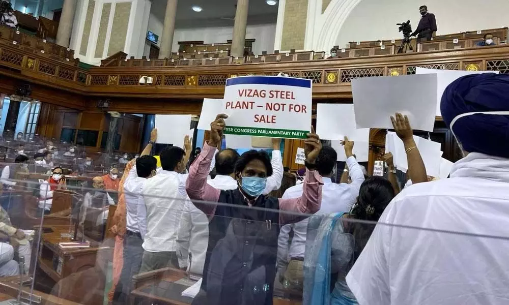 Visakhapatnam MP MVV Satyanarayana displaying a placard opposing privatisation of VSP in the Lok Sabha on Tuesday