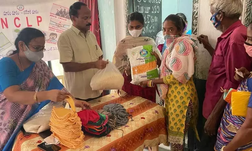 Additional Commissioner, Labour department D Anjaneya Reddy distributing ration to parents at the Special NCLP school  in Vijayawada on Tuesday