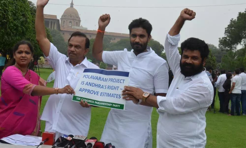 YSRCP MPs raise hands while addressing the media over Polavaram issue  outside the Parliament building in New Delhi on Tuesday