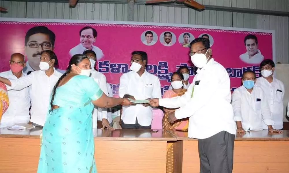 Minister Ajay Kumar distributing cheques to beneficiaries at his camp office in Khammam on Tuesday
