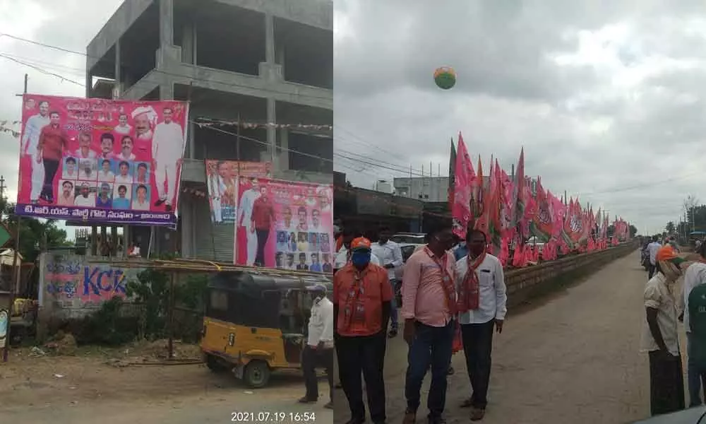 Banners of BJP and TRS placed side-by-side at a busy junction in Huzurabad