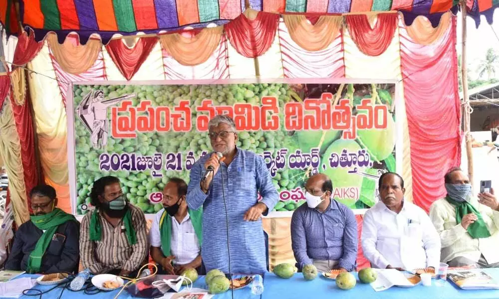 AP Rythu Sangham general secretary K V Prasad addressing a symposium organised to mark the World Mango Day at Market Yard in Chittoor on Wednesday