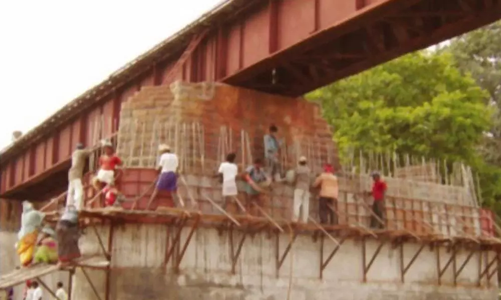 Workers strengthening railway bridge under Guntakal Division