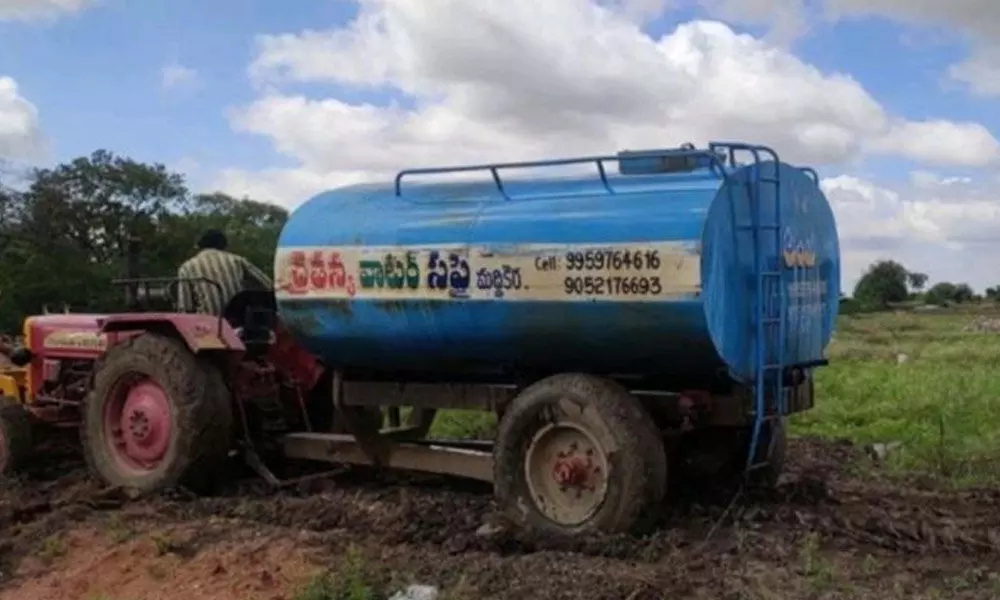 Beneficiaries of Jagananna housing colony in Maddikerra village hiring water tankers to construct houses