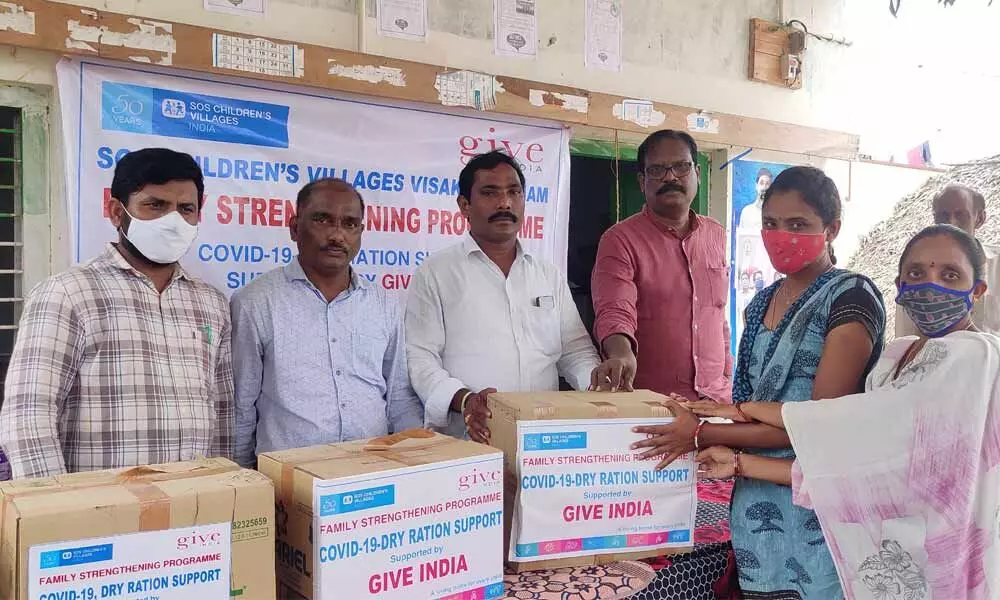 SOS Children’s Village representatives distributing essential commodities to the needy people in Korada panchayat on Wednesday