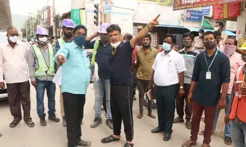 Town planning officials explaining the Commissioner Girisha on the proposed road on both sides of Garuda Varadhi in Tirupati on Wednesday. Town planning officials explaining the Commissioner Girisha on the proposed road on both sides of Garuda Varadhi in Tirupati on Wednesday.