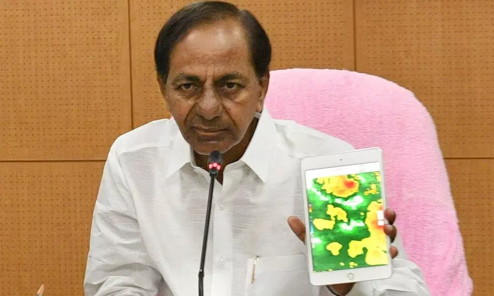 Chief Minister K Chandrasekhar Rao displays the forecast for Telangana during an emergency meeting in Hyderabad on Thursday