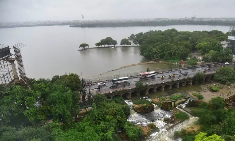 With good inflows into Hussainsagar, excess rainwater being released from the reservoir in Hyderabad on Thursday Photo: Adula Krishna