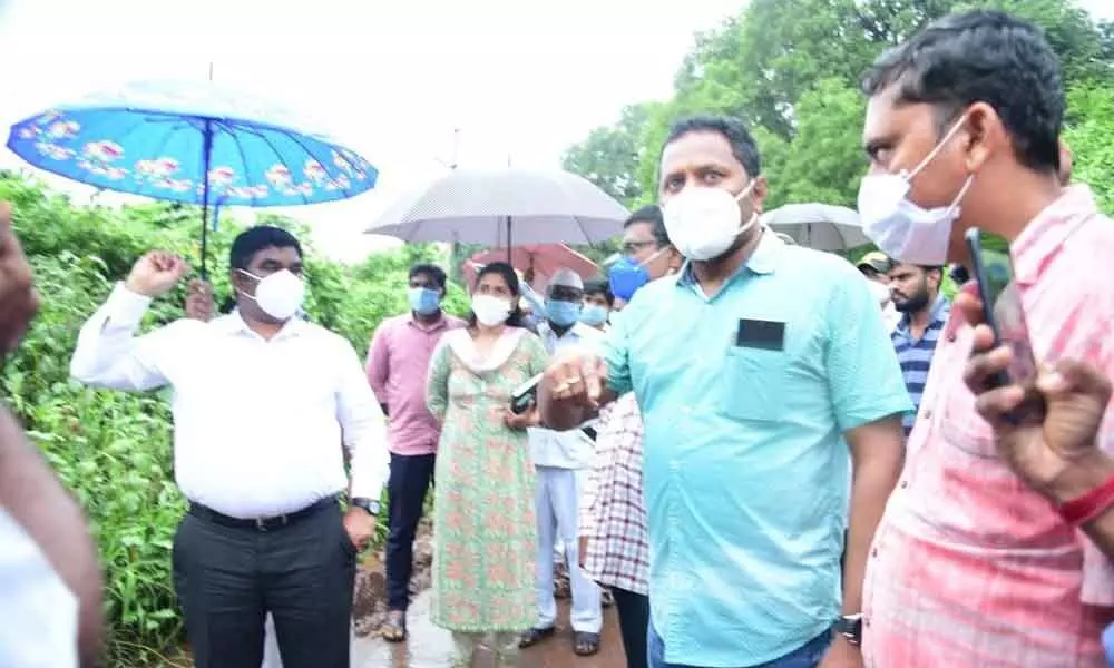 District Collector G Veera Pandian, along with Nandyal Sub-Collector Chahat Bajpai, examining an overflowing stream near Mahanandi in Nandyal on Thursday.