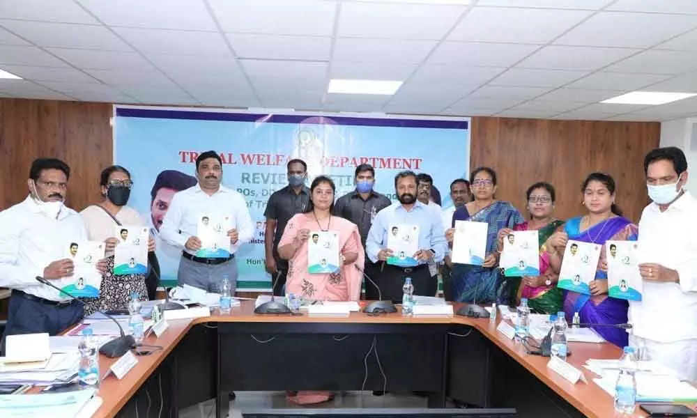 Deputy Chief Minister Pushpasreevani  along with MLAs and officials releasing the two-year progress report of the  Tribal welfare department in Vijayawada on Thursday