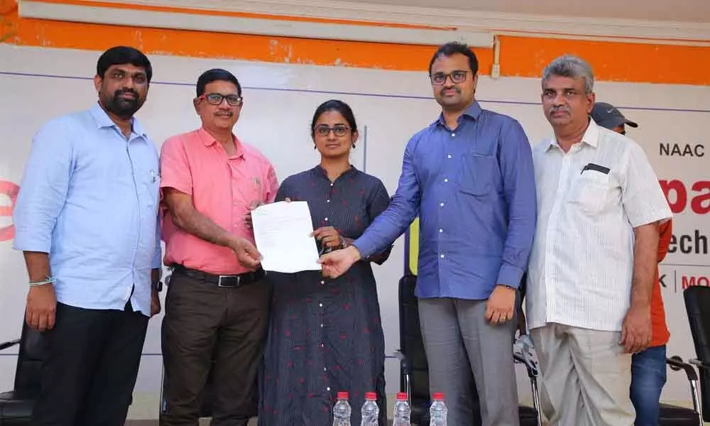 Chalapathi Institute of Technology management congratulating a student on securing a job during the campus placement drive in Guntur on Thursday
