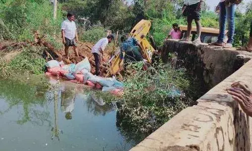A breached village tank being repaired near Tadipatri