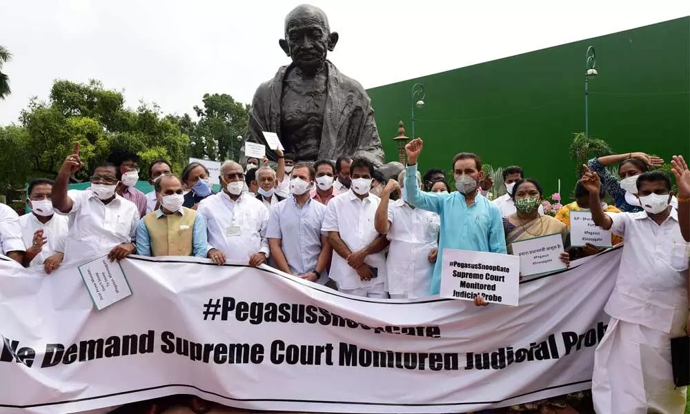 Congress leader Rahul Gandhi with party leaders, DMK and other parties MPs stage a protest near the Gandhi statue against Pegasus project, during the Monsoon Session of Parliament, in New Delhi on Friday