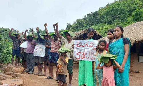Tribals staging a novel protest to gain access to power at Jeedugulalova in Ravikamatam mandal in Visakhapatnam district on Friday