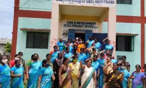 Anganwadi workers staging a protest in front of ICDS office in Adoni on Friday