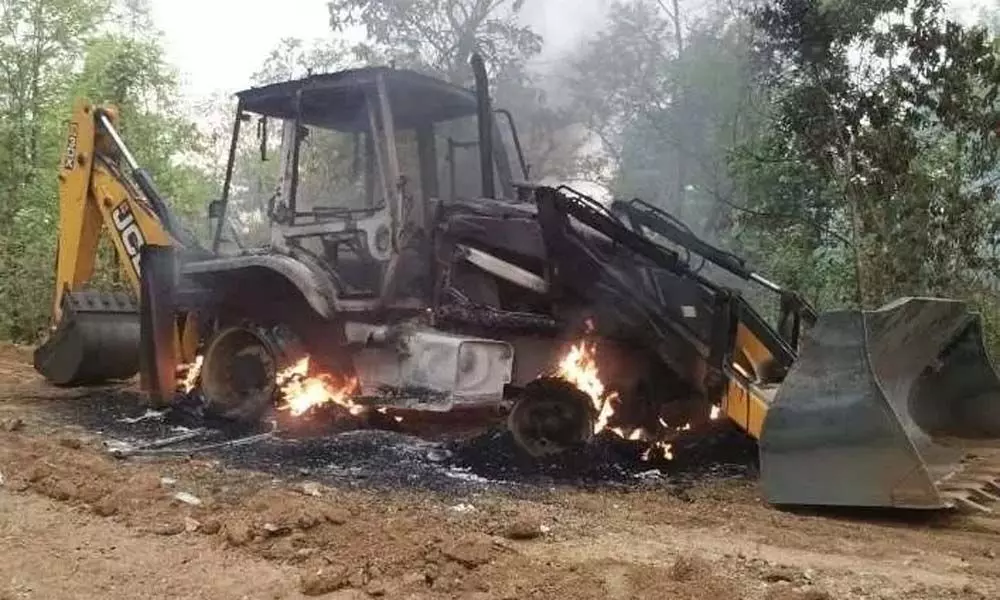 Maoists set afire six vehicles of a private road construction company in Jharkhand