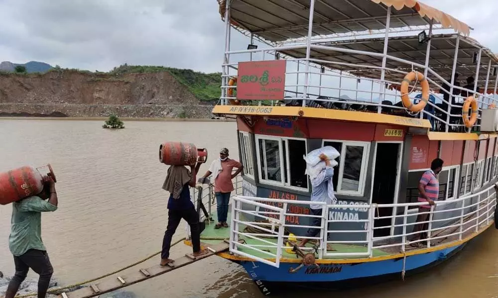 People loading their belongings on the boat to shift them to relief centres on Sunday