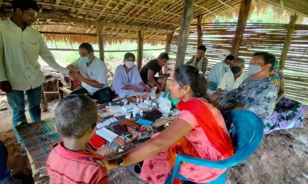 Tribals getting their health examined as the health staff reaches Pasuvalabanda village at V Madugula mandal in Shymalamma hill on Sunday.
