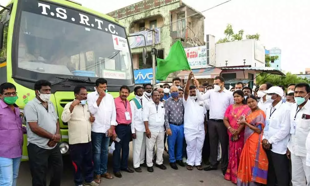 Collector RV Karnan and SC Corporation Chairman B Srinivas flagged off buses bound for Hyderabad from Huzurabad in Karimnagar district on Monday