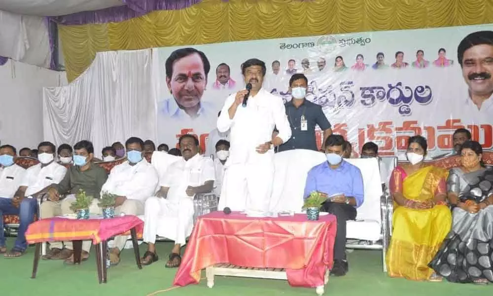 Minister Prashant Reddy addressing a gathering during a function held to distribute food security cards