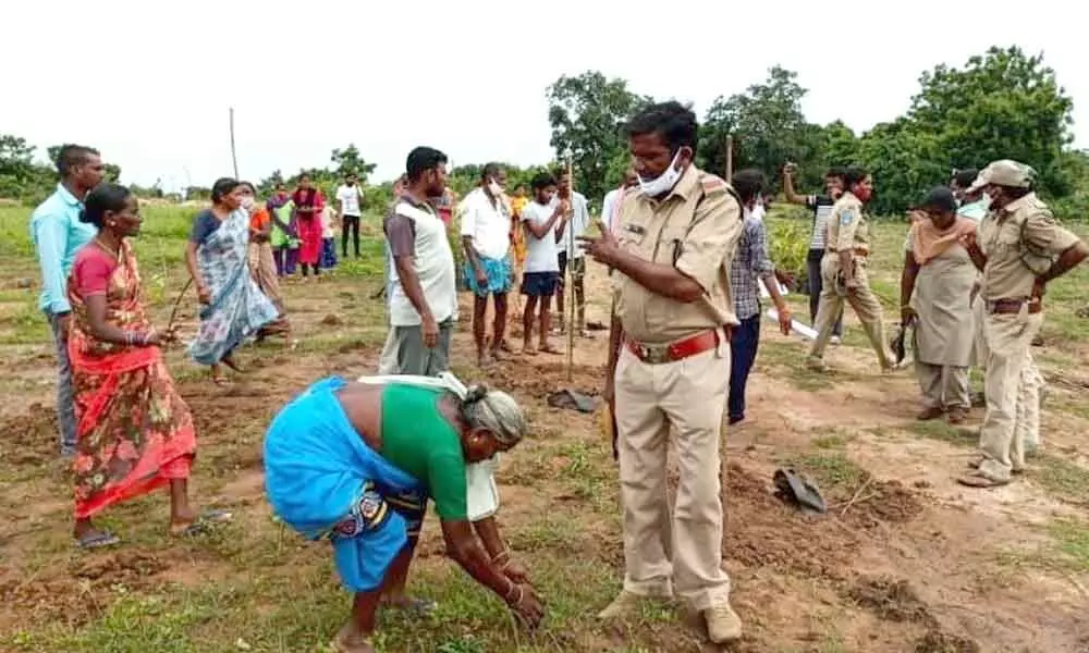 A Dalit woman falls at the feet of forest official at Bollepally village under Gudur mandal in Mahabubabad district on Monday