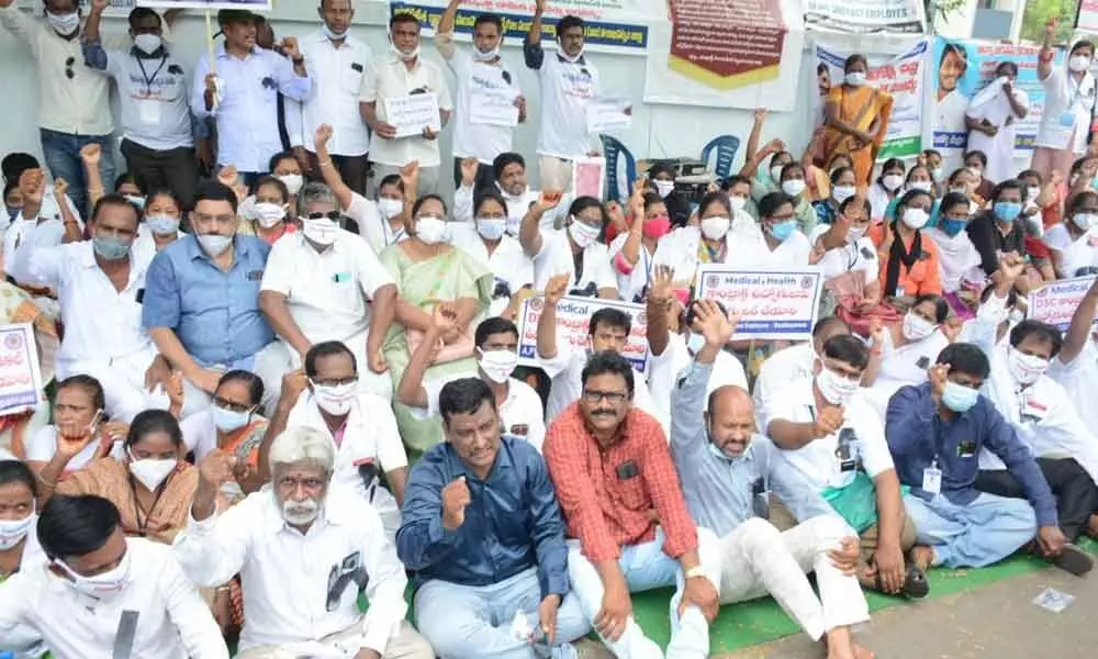 Contract paramedical employees staging a protest in Visakhapatnam on Monday