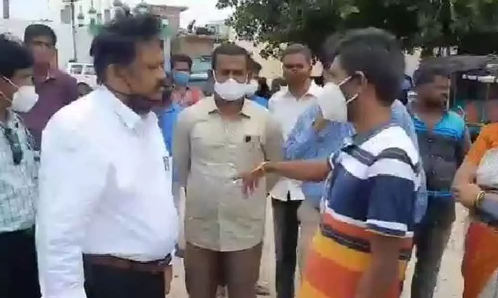 Additional District Medical and Health Officer Dr Vinod Kumar along with RWS EE Manohar and others interacting with Anugonda villagers on Monday.