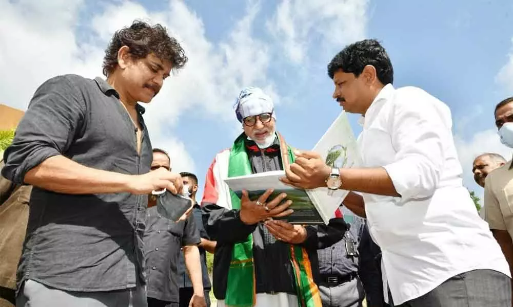 Actor Amitabh Bachchan enquiring about the Green India Challenge with its founder Joginapally Santosh Kumar on Tuesday. Amitabh Bachchan along with actor Nagarjuna planted saplings in Ramoji Film City on Tuesday