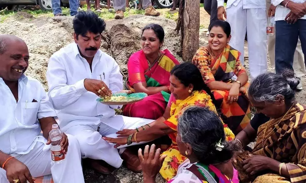 Mahabubabad MLA Banoth Shankar Naik feeding the residents of Bollepally village in Gudur mandal on Tuesday