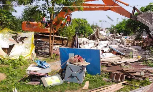 Police demolishing houses in Kothagudem on Tuesday