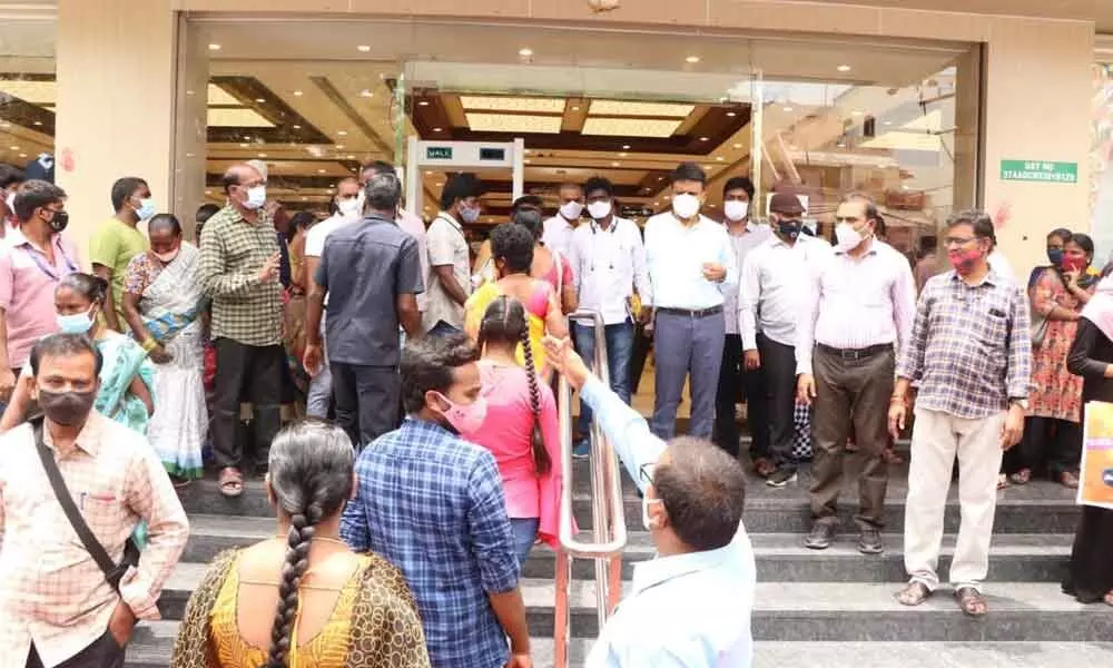 Municipal Commissioner P S Girisha and other officials during an inspection of a  shoping mall in Tirupati on Wednesday