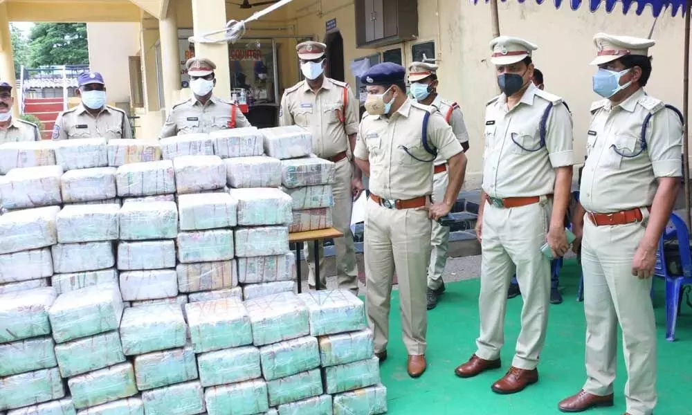 Police Commissioner Vishnu S Warieer examining the seized ganja packets in Khammam on Wednesday