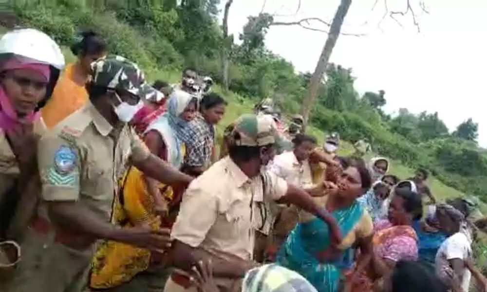 Tribals, officials enter into a scuffle over podu land at Regallapadu village in Khammam on Thursday