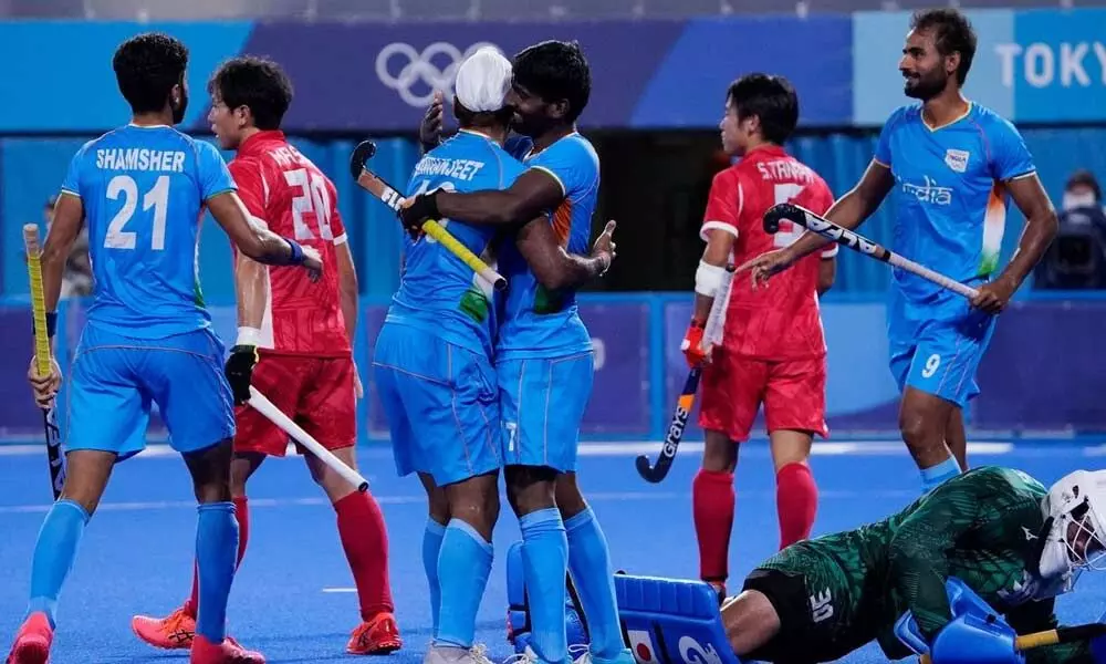 Indian players celebrate after scoring against Japan during a mens field hockey match at the 2020 Summer Olympics on Friday