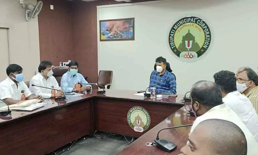 SVVMC members speaking to Municipal Commissioner P S Girsha at his chamber in Municipal Office in Tirupati on Saturday