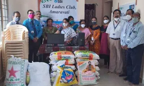 SBI staff and Mathrusya Child and Old age home in-charge Sri Devi with the donated items in Tirupati on Saturday