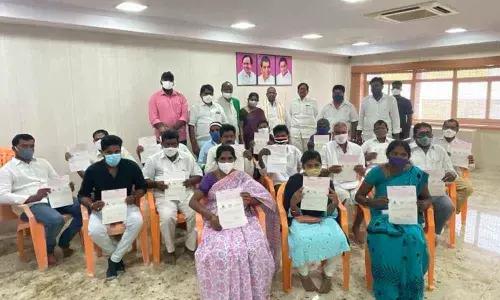 Beneficiaries displaying the CMRF cheques at the MP Nama Nageswara Rao Camp office in Khammam on Saturday