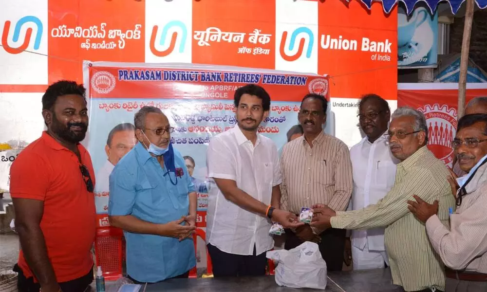Magunta Raghava Reddy distributing Anandaiahs herbal mix to bankers and retirees in Ongole on Sunday