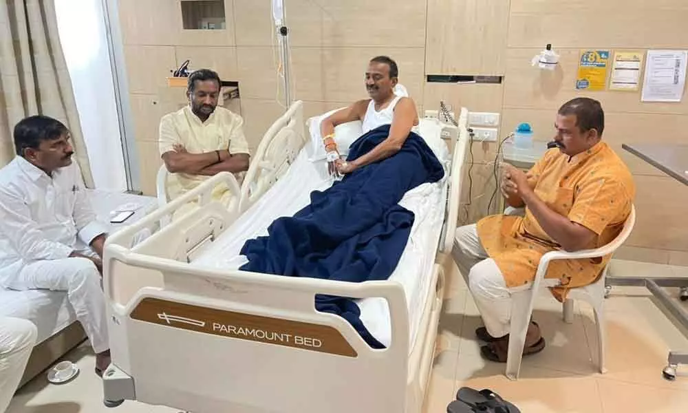 BJP MLAs T Raja Singh and M Raghunandan Rao enquiring about the health of party leader EatalaRajender at a city hospital in Hyderabad on Sunday