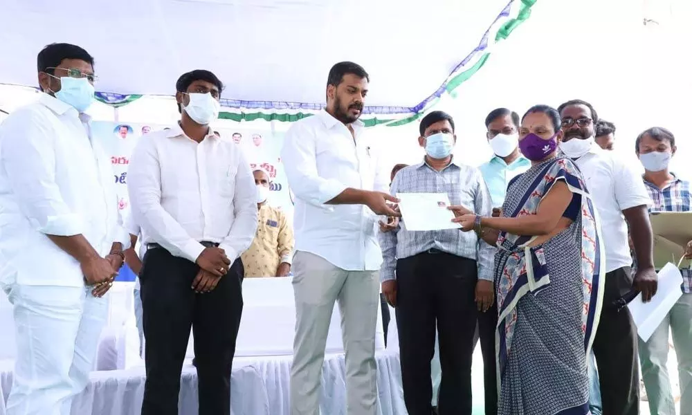 Water Resources Minister Dr P Anil Kumar Yadav distributing house pattas to the beneficiaries at Vaikunthapuram in Nellore on Sunday