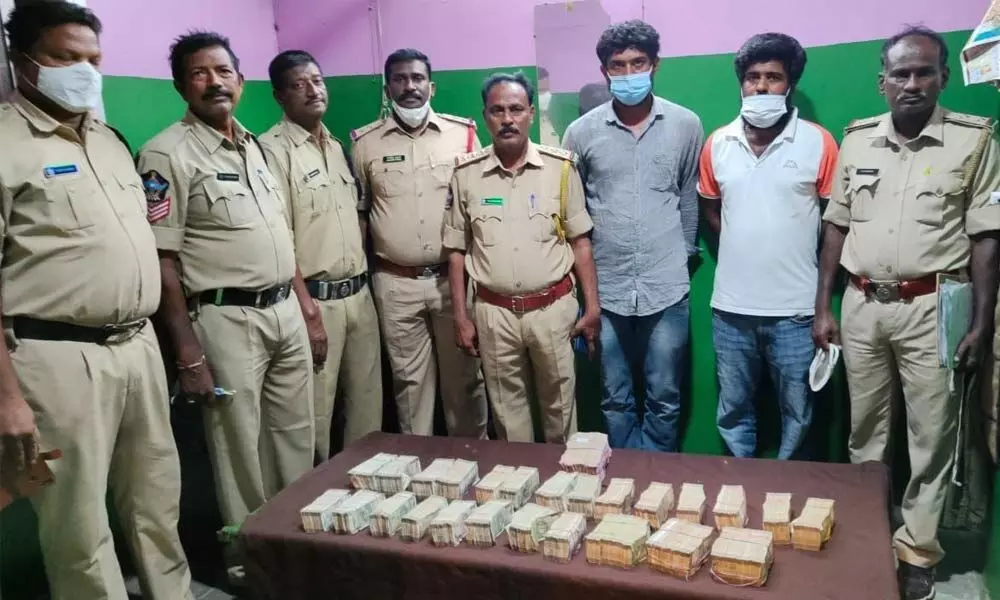 SEB Circle Inspector P Srinivasulu and his staff with the seized unaccounted cash at Panchaligala border check post on Sunday