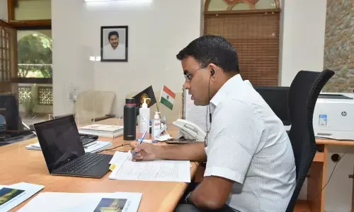 District Collector Vivek Yadav conducting teleconference with officials at his camp office in Guntur on Sunday