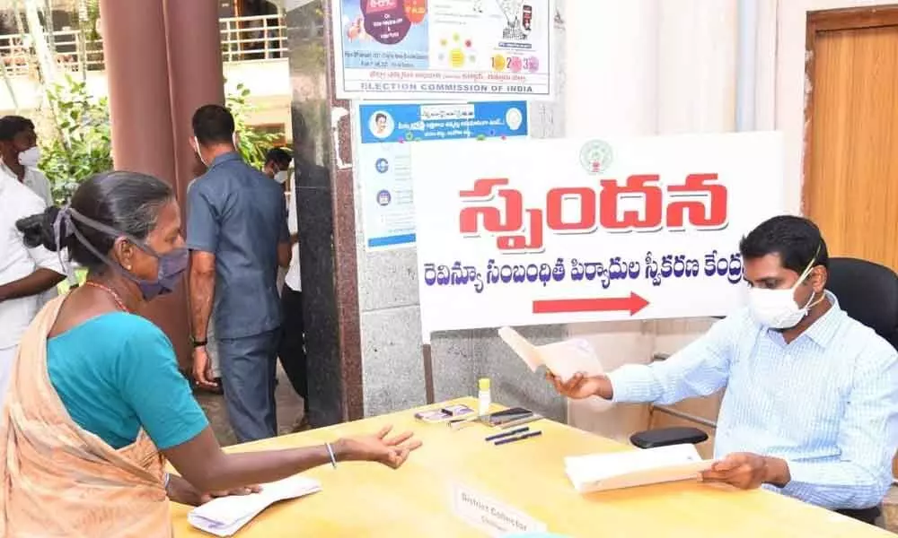 District Collector M Hari Narayanan receiving petitions at Spandana programme in Chittoor on Monday.