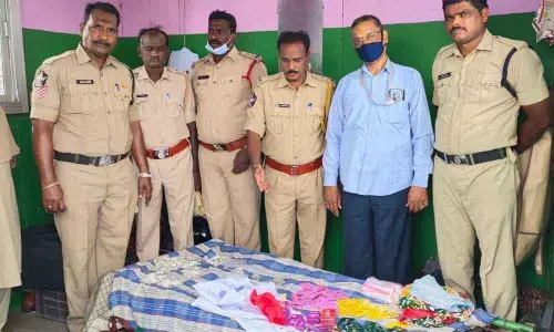 SEB Circle Inspector P Srinivasulu and his staff with seized gold and silver coins at Panchalingala border check post on Monday.